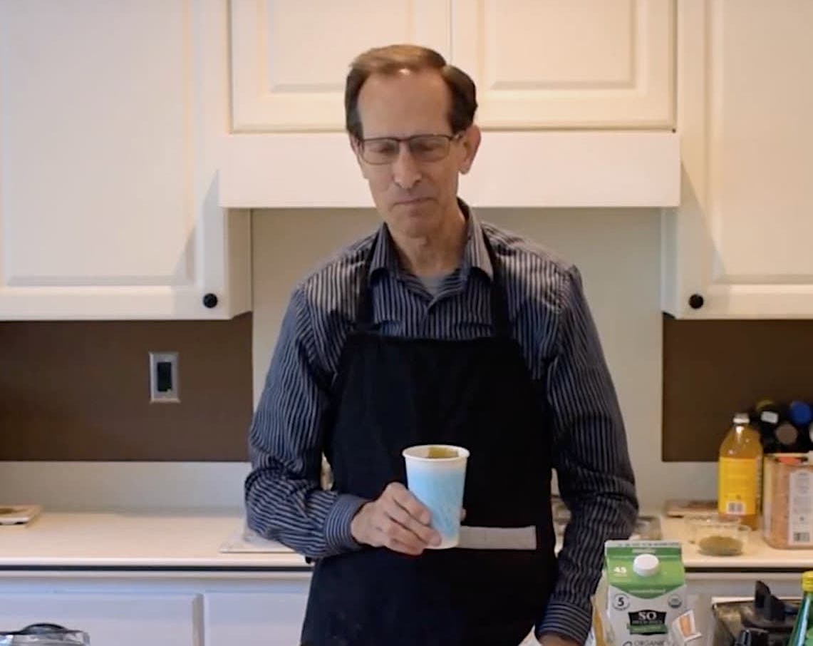 Alan holding a cup of MyShroom smoothie